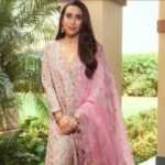 Karisma Kapoor wearing an elegant embroidered ivory and blush pink designer salwar set at a jewellery event